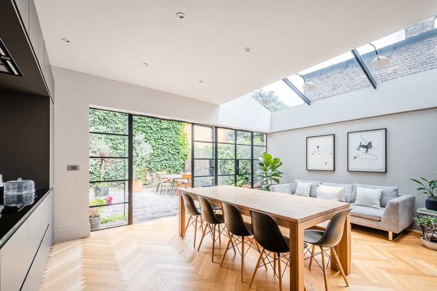 Completed London basement conversion with polished concrete floor and light well