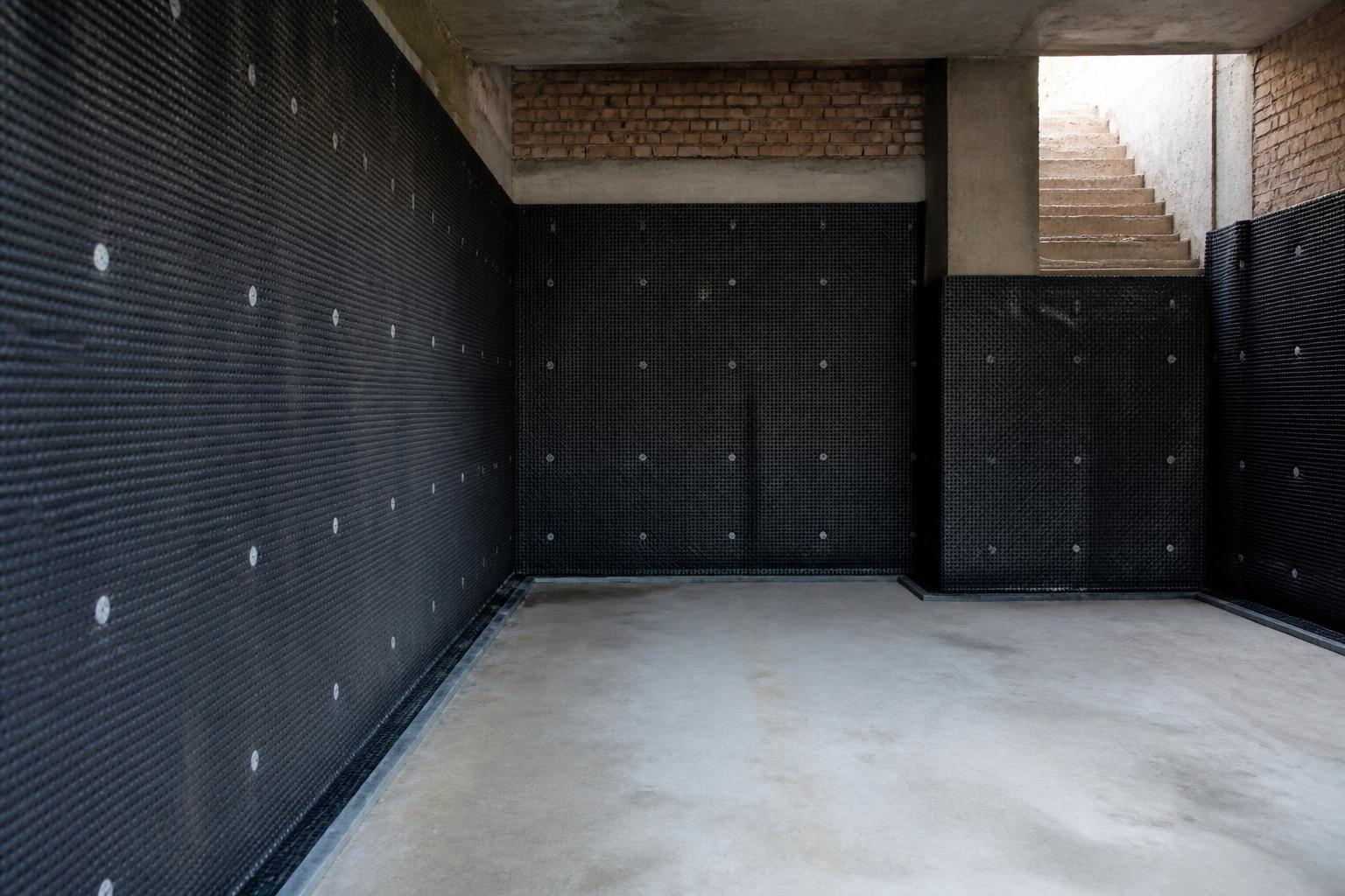 Type-C cavity drain membrane waterproofing installed to a London basement wall